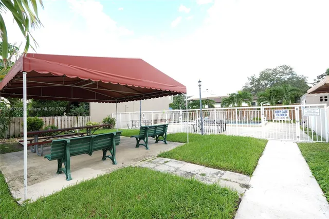 a view of a deck with table and chairs with wooden fence