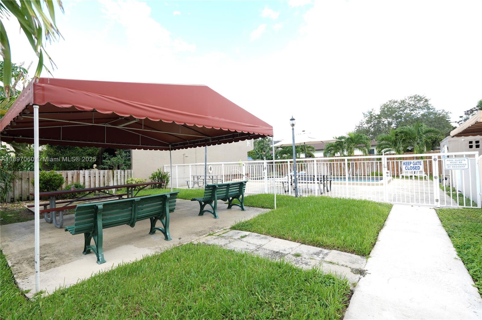 3791 Northwest 78th Avenue, Unit 24 Davie, FL 33024 - Photo 5 of 22 a view of a deck with table and chairs with wooden fence