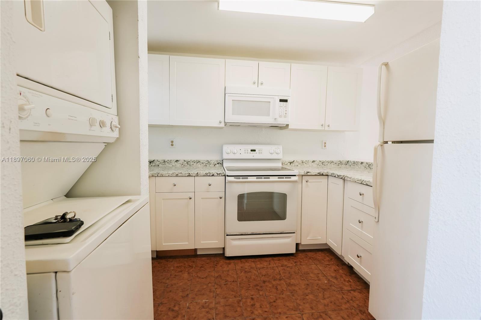 3791 Northwest 78th Avenue, Unit 24 Davie, FL 33024 - Photo 10 of 22 a kitchen with white cabinets and white appliances