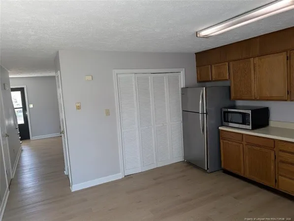 a kitchen with a refrigerator and a sink