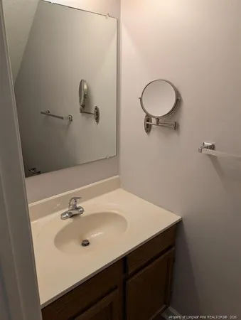 a bathroom with a sink mirror and vanity