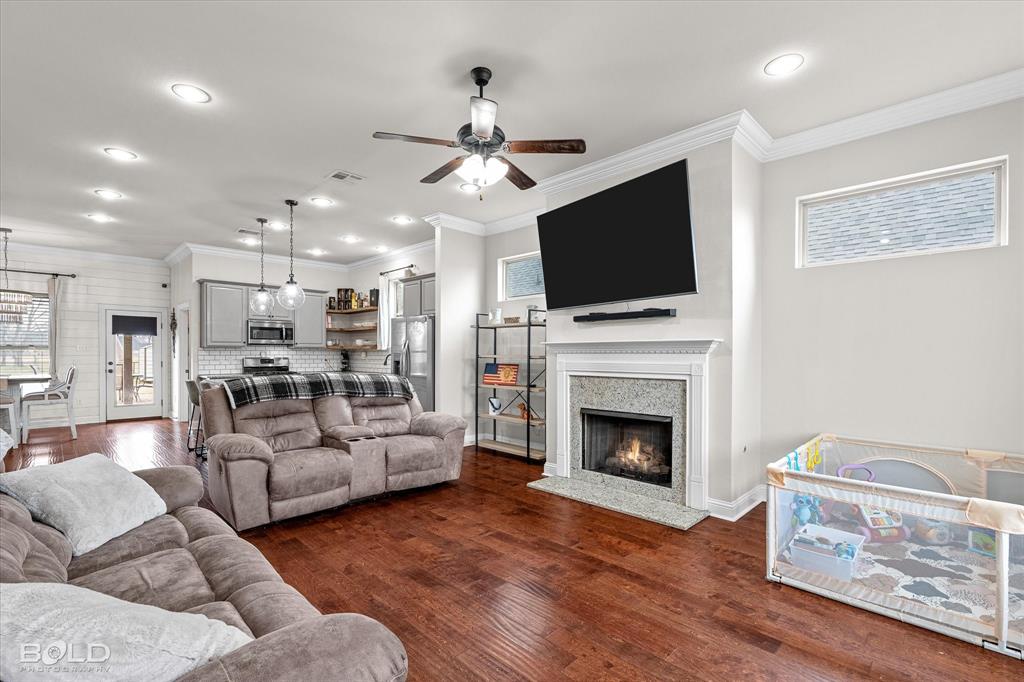 946 Maize Street Bossier City, LA 71111 - Photo 17 of 39 a living room with furniture a flat screen tv and a fireplace