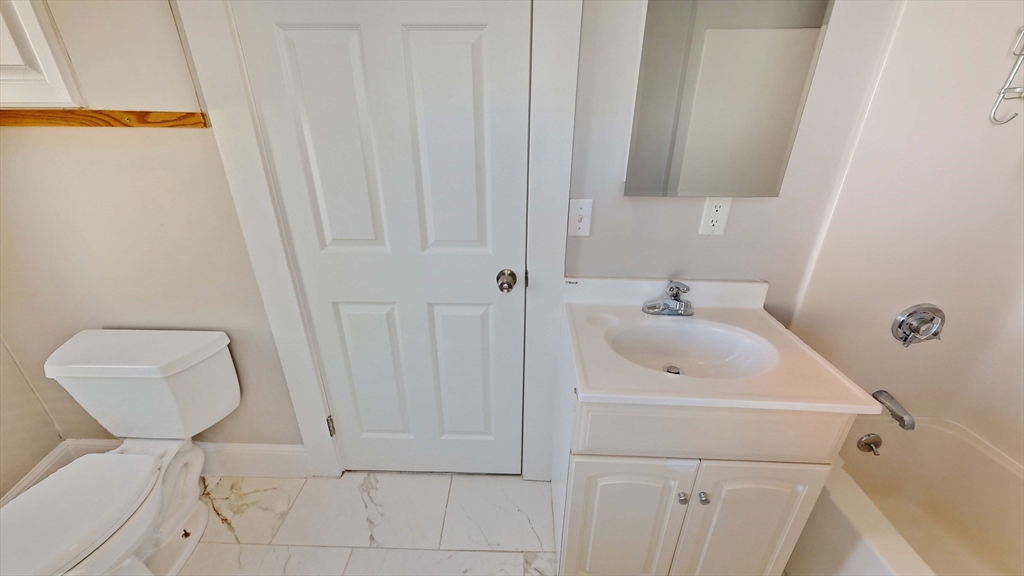 40-42 Upham Street, Unit 1 Malden, MA 02148 - Photo 10 of 17 a bathroom with a sink and a toilet