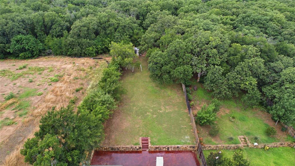 10001 Thurman Road Fort Worth, TX 76244 - Photo 38 of 40 Expansive property featuring a large grassy area, surrounded by a natural treeline