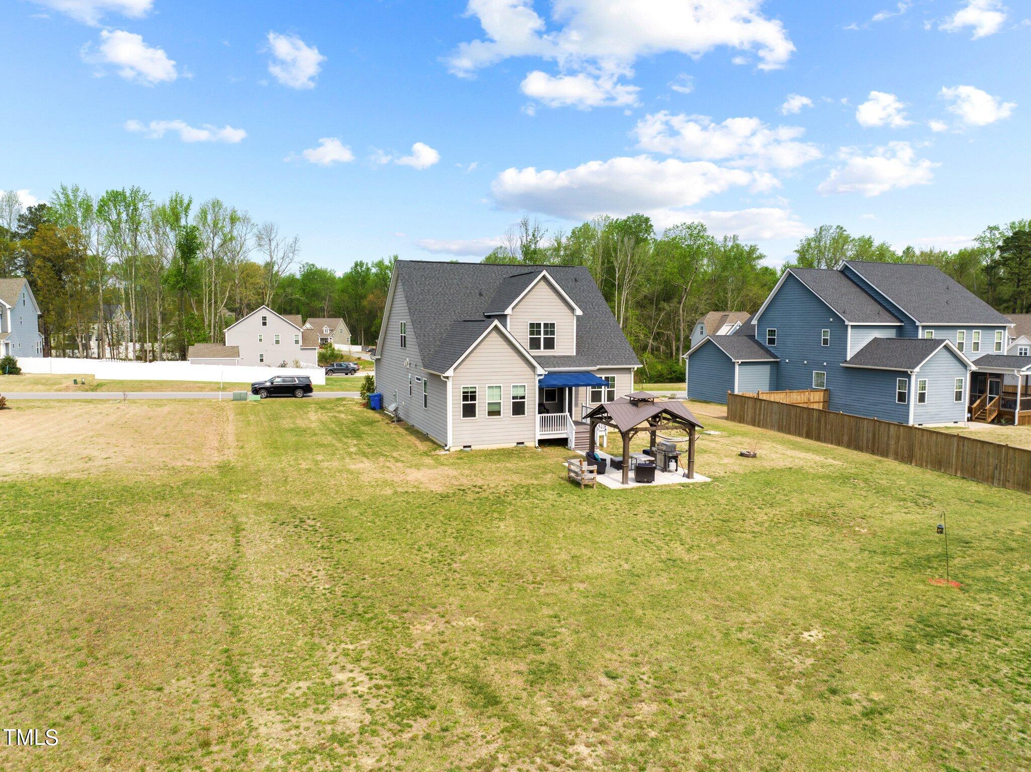 901 Peterson Ridge Road Fuquay-Varina, NC 27526 - Photo 22 of 23 a view of a house with pool and chairs