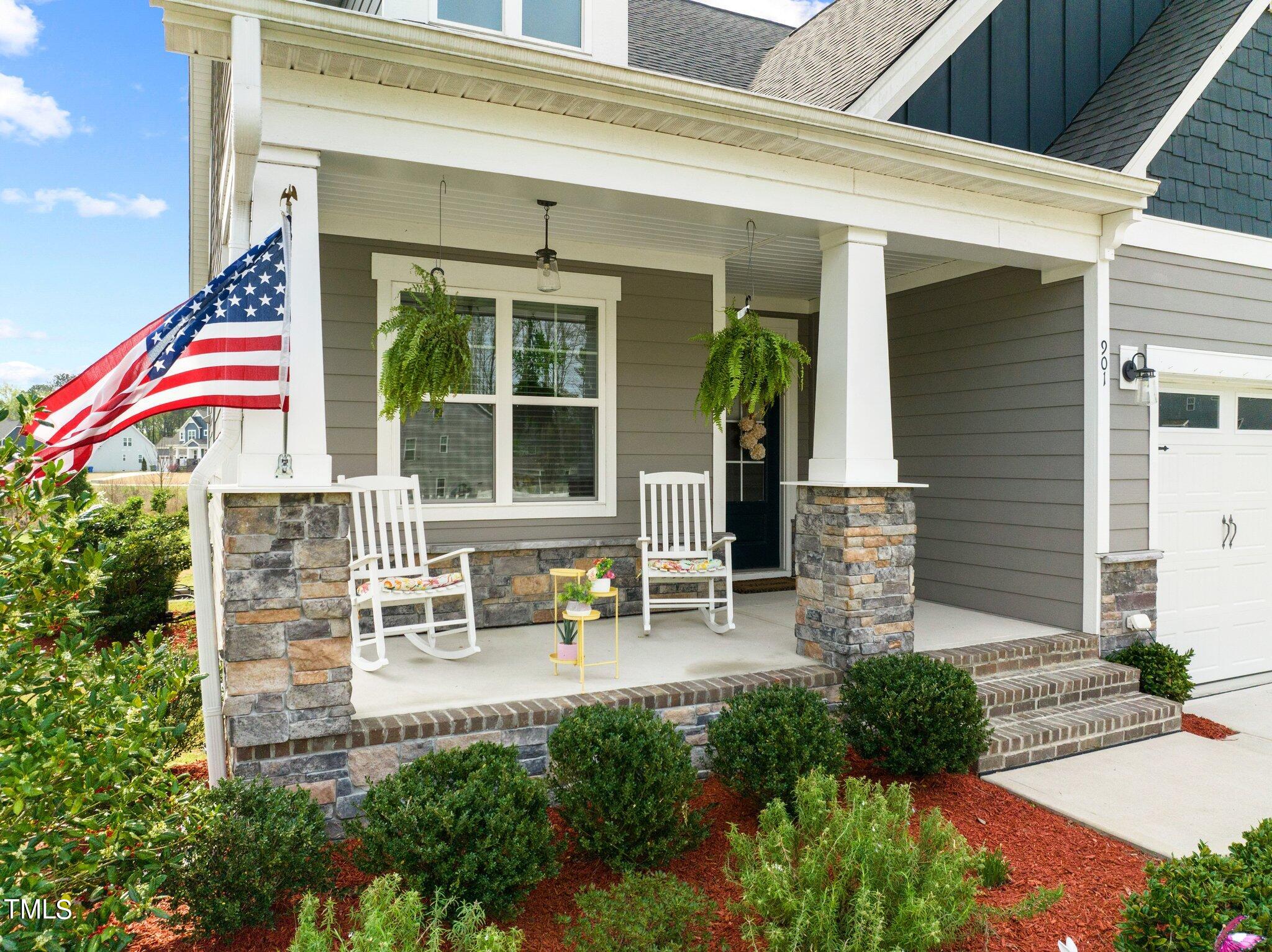 901 Peterson Ridge Road Fuquay-Varina, NC 27526 - Photo 3 of 23 a front view of a house with outdoor seating and plants