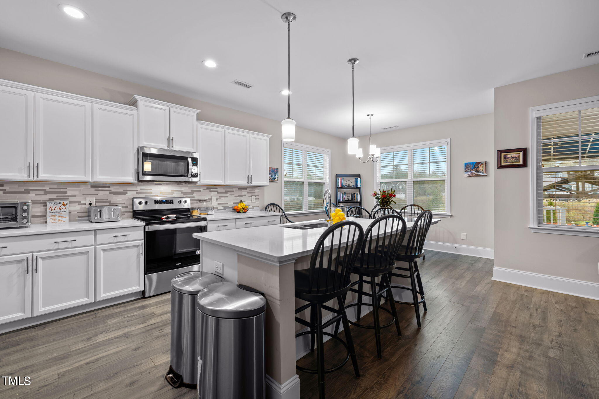 901 Peterson Ridge Road Fuquay-Varina, NC 27526 - Photo 8 of 23 a kitchen with stainless steel appliances granite countertop a stove a sink a microwave a center island and chairs