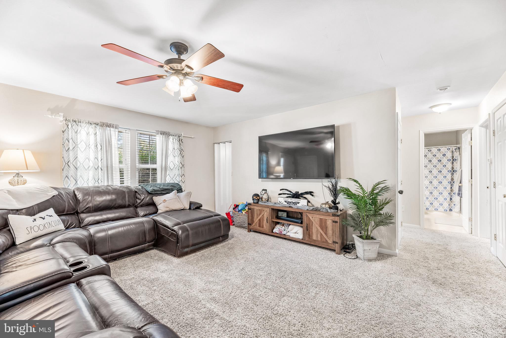 11156 Rawhide Road Lusby, MD 20657 - Photo 11 of 33 a living room with furniture and a flat screen tv