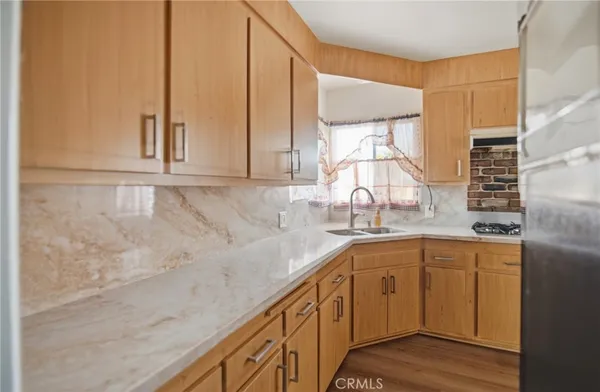 a kitchen with a sink cabinets and window
