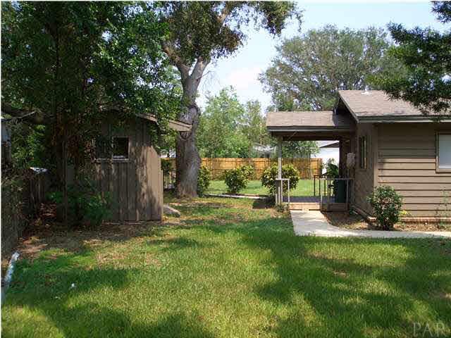 110 Majors Road Pensacola, FL 32503 - Photo 3 of 18 Left side view of house with Storage Unit and Covered Rear Porch