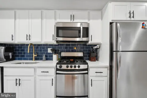a kitchen with stainless steel appliances a stove and a refrigerator