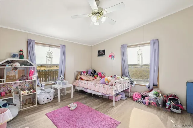 a bedroom with furniture toys and a window