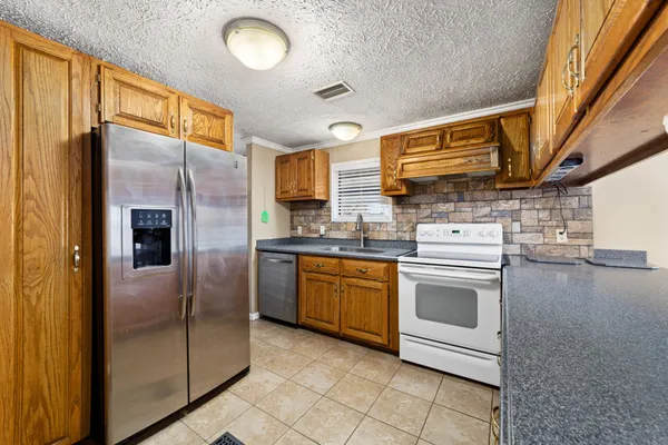 a kitchen that has a sink and a stove
