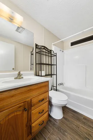 a bathroom with a double vanity sink toilet mirror and shower