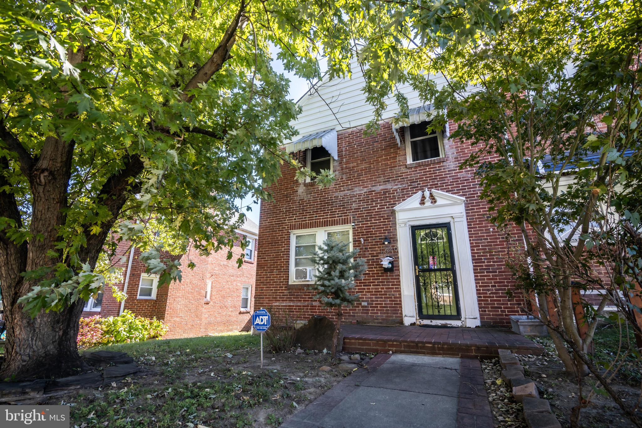 front view of a house with a garden