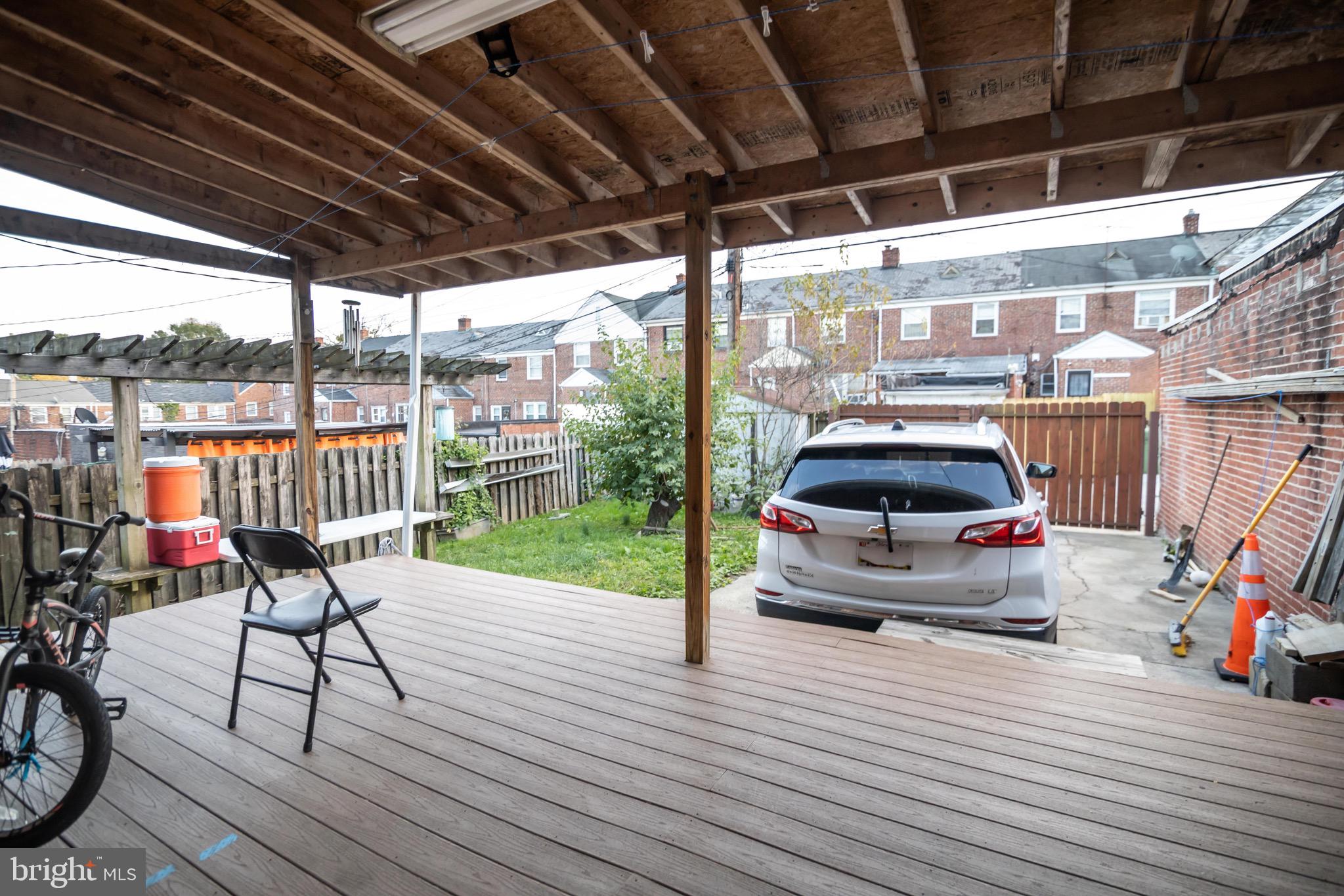 1649 Ralworth Road Baltimore, MD 21218 - Photo 4 of 47 a view of a patio with wooden floor table and chairs