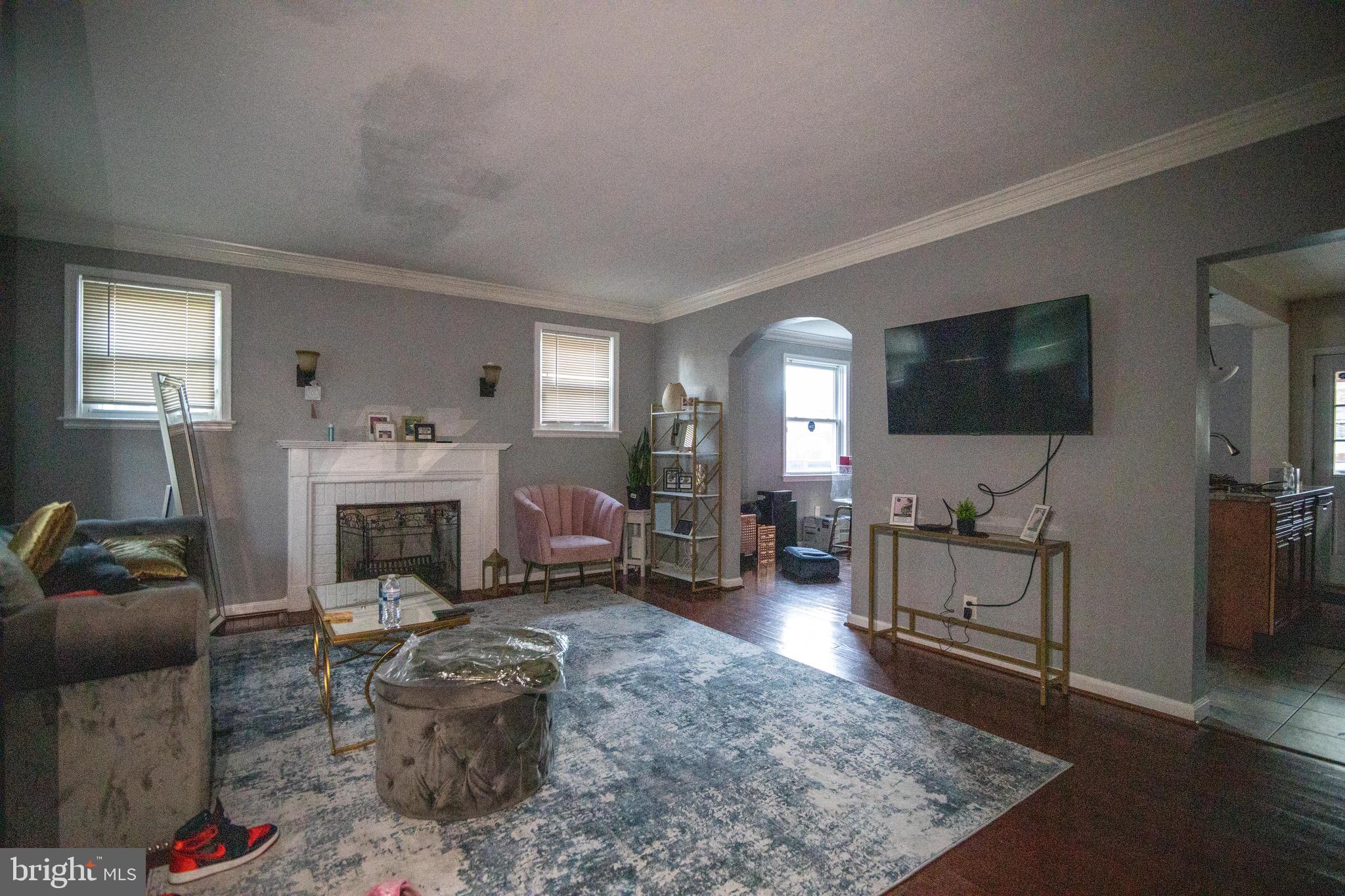 1649 Ralworth Road Baltimore, MD 21218 - Photo 45 of 47 a living room with furniture a flat screen tv and a fireplace