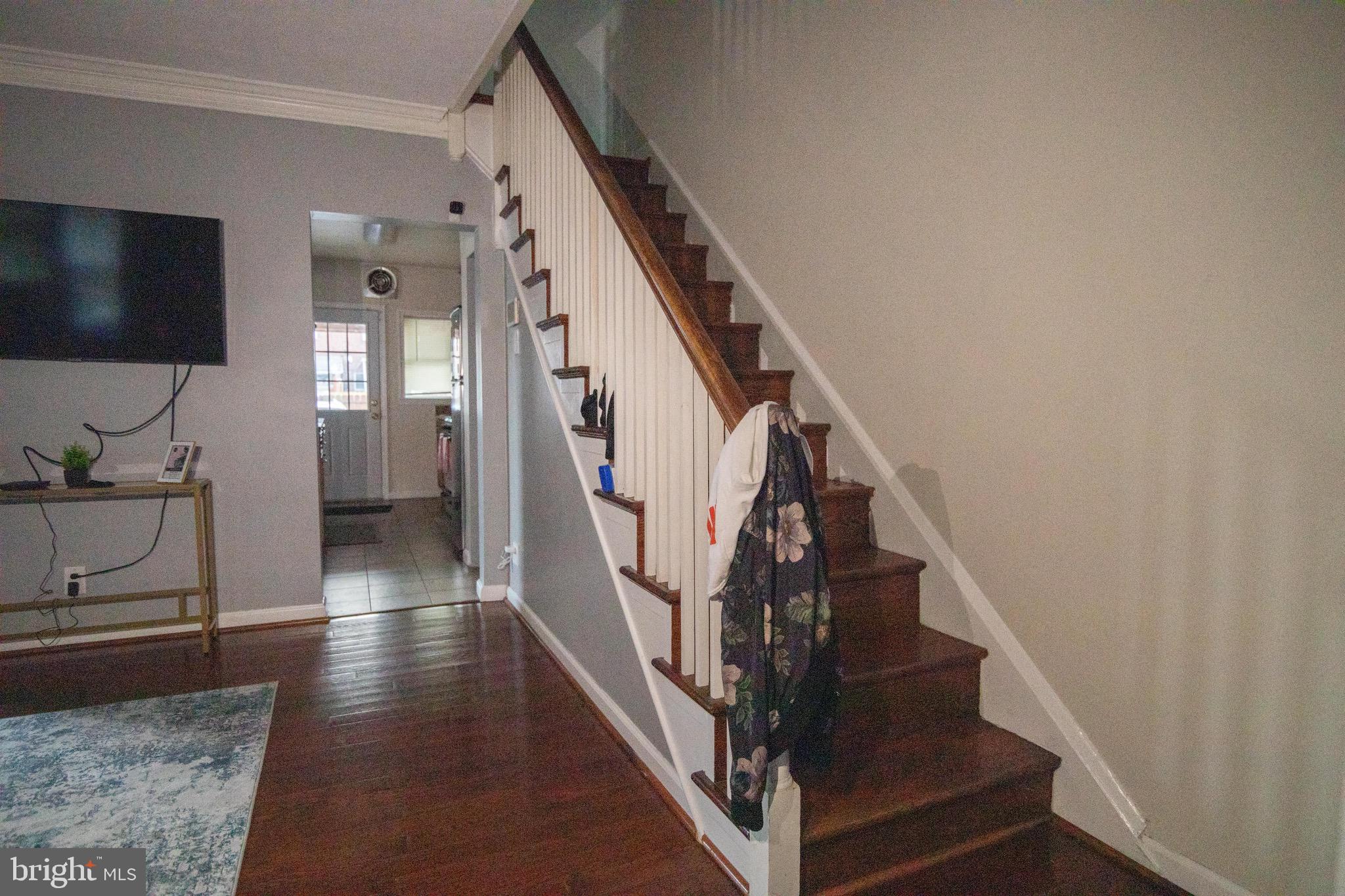 1649 Ralworth Road Baltimore, MD 21218 - Photo 47 of 47 a view of a hallway with wooden floor and staircase