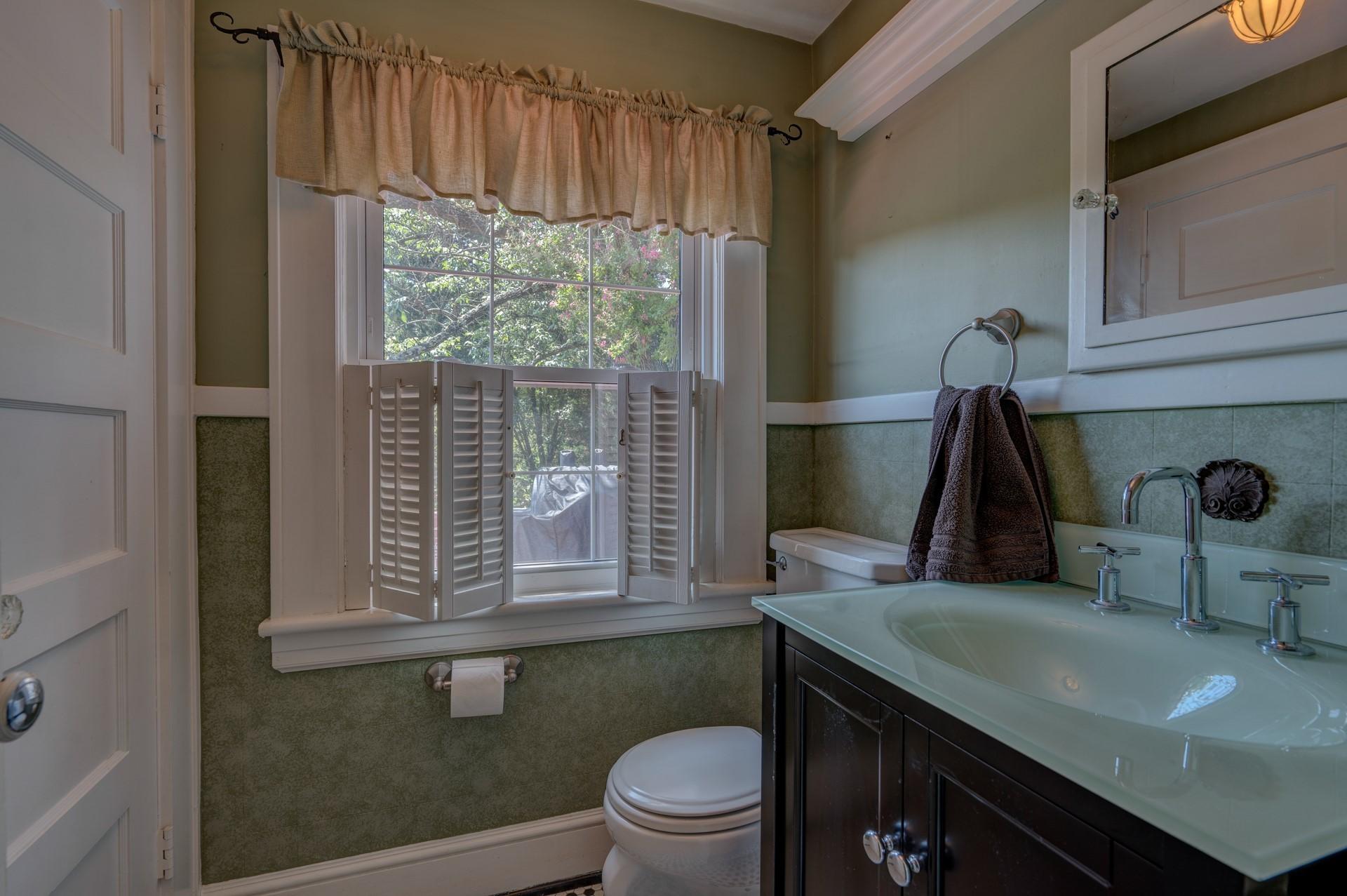 1502 Terrace Road Southwest Roanoke, VA 24015 - Photo 19 of 35 a bathroom with a sink a toilet and a window