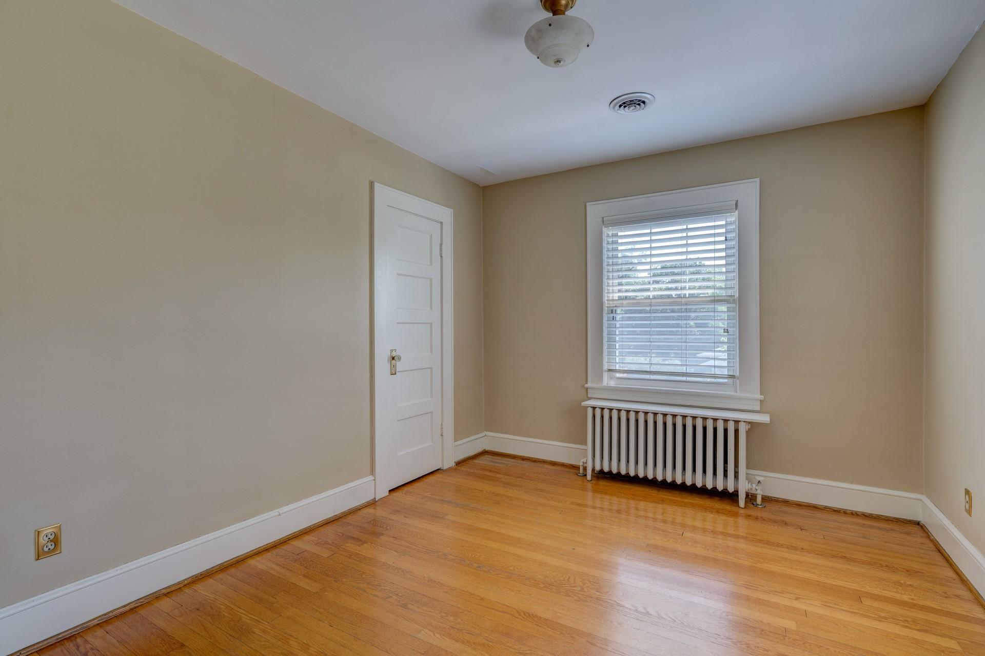 1502 Terrace Road Southwest Roanoke, VA 24015 - Photo 26 of 35 an empty room with a window and wooden floor
