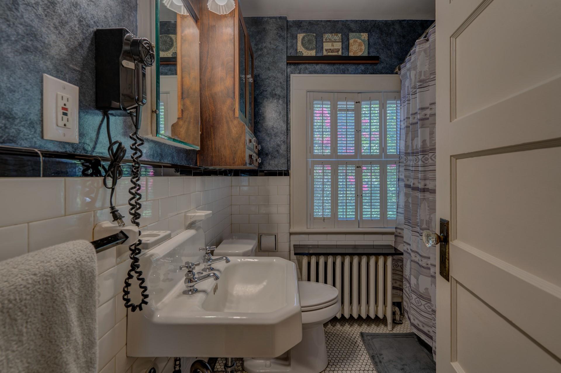 1502 Terrace Road Southwest Roanoke, VA 24015 - Photo 27 of 35 a bathroom with a sink and a mirror