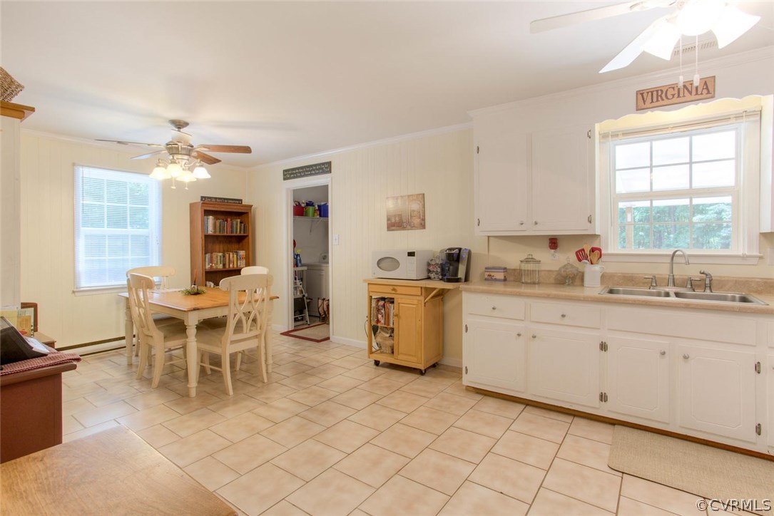 11841 River Road Chesterfield, VA 23838 - Photo 18 of 32 a kitchen with granite countertop cabinets a dining table and chairs