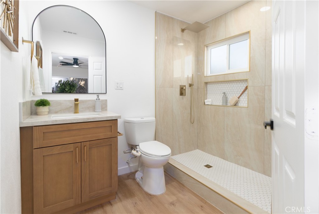 3306 Debbie Lane Riverside, CA 92501 - Photo 23 of 32 a bathroom with a sink a toilet and shower