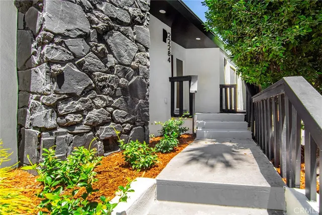 a living room with furniture large window and flat screen tv