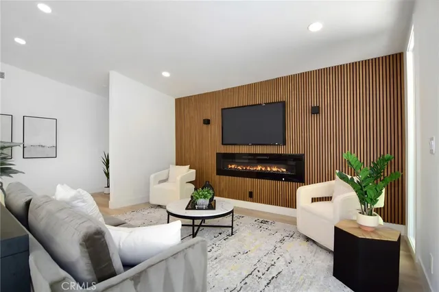a view of a dining room with furniture a rug and wooden floor