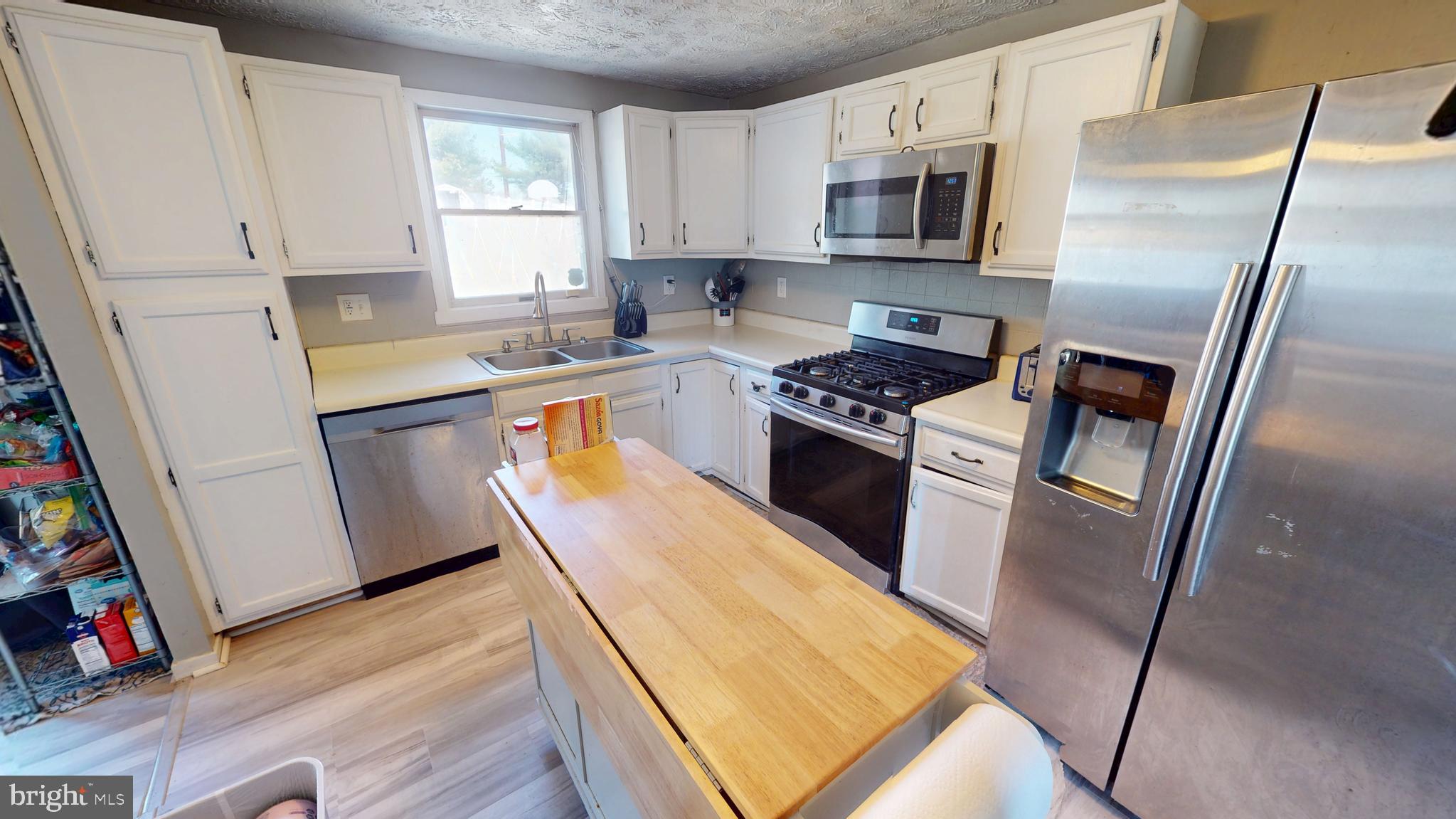 37 Decatur Lane Sicklerville, NJ 08081 - Photo 12 of 26 a kitchen with granite countertop a refrigerator a sink a stove a microwave and wooden floor