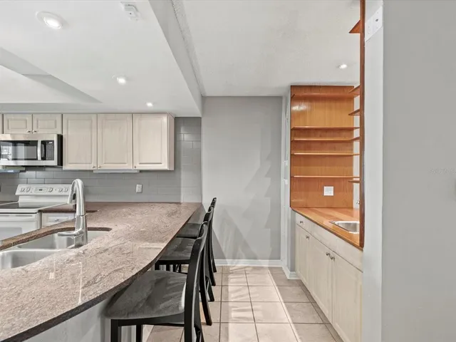 a kitchen with white cabinets and counter space