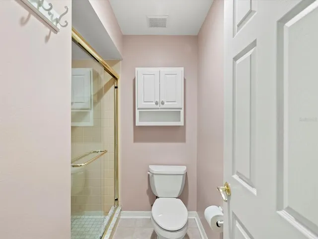 a white toilet sitting next to a bathroom sink and vanity