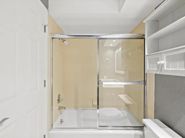a bathroom with a glass shower door