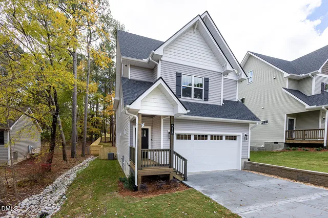 a front view of a house with a yard and garage