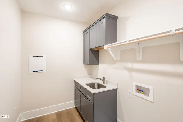 a living room with furniture a large window and a chandelier