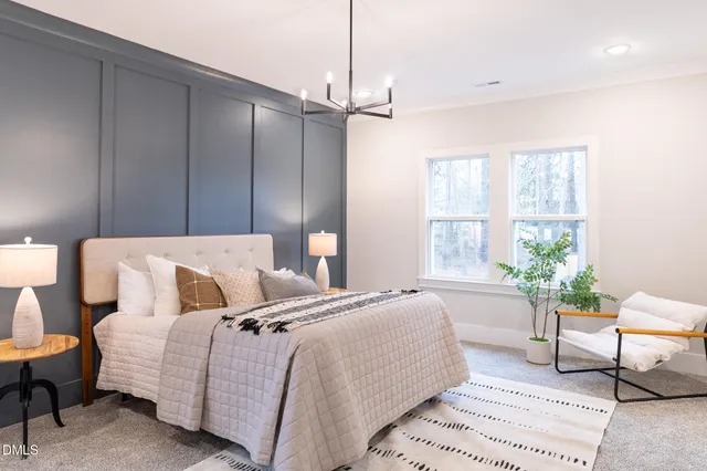 a bedroom with a bed and a chandelier