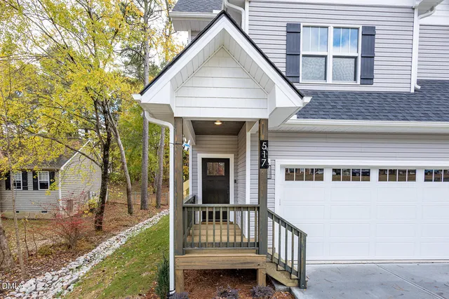 a view of a house with a yard and wooden fence