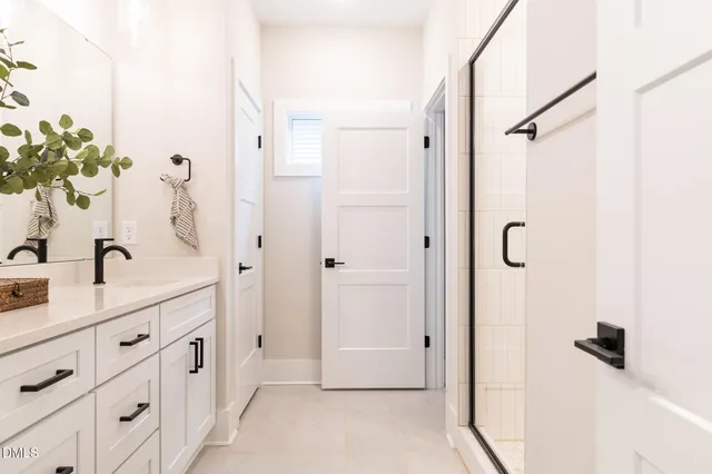 a bathroom with a glass shower door