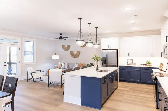 a large room with stainless steel appliances kitchen island granite countertop a sink and cabinets