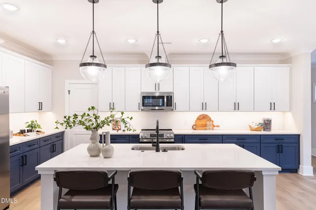 a kitchen with a dining table a sink and cabinets