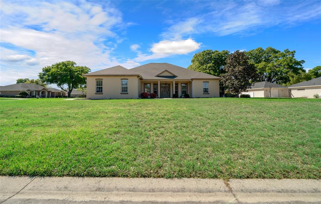 5073 Southeast 39th Loop Ocala, FL 34480 - Photo 1 of 85 a front view of a house with a yard