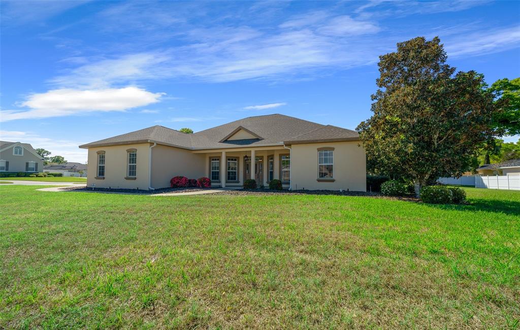 5073 Southeast 39th Loop Ocala, FL 34480 - Photo 5 of 85 a front view of a house with a garden