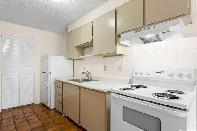 a kitchen with a sink cabinets and appliances