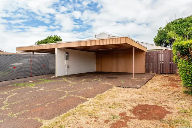 a backyard of a house with wooden fence and garage