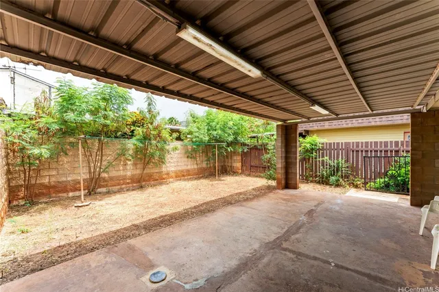 a porch with a table and chairs next to window