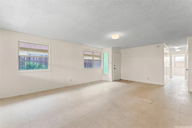 an empty room with a empty space and windows