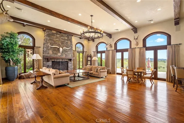 a view of a dining room with furniture wooden floor and chandelier