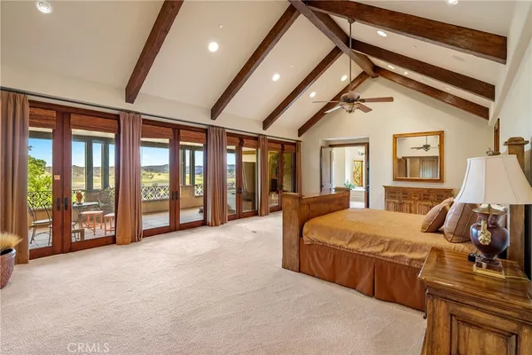 a spacious bedroom with a large bed and a window