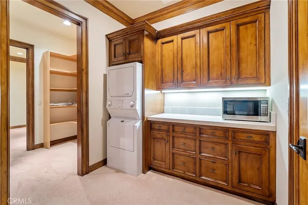 a front view of a house with a garden and trees