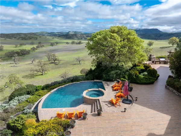 a view of a swimming pool and trees in the background
